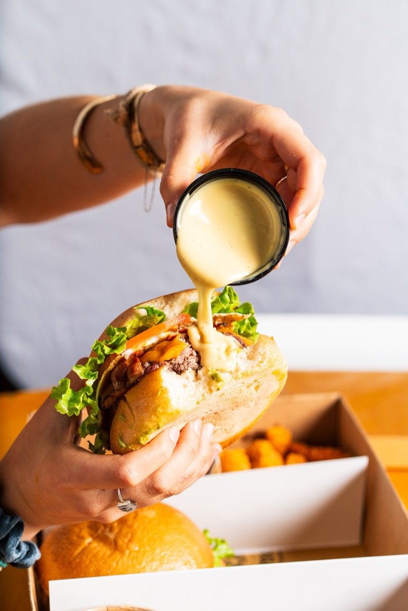 Burger being lifted from a plate